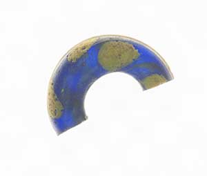 A glass bead coloured blue with cobalt. It was found in the Iron Age settlement and could have been part of a necklace.